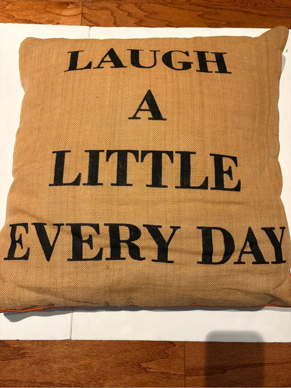 Laugh A Little Every Day Burlap Accent Pillow - Tan with Black Letters.